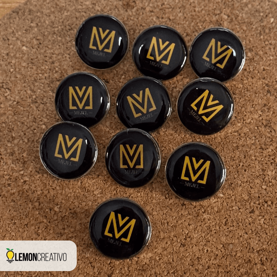 Batch of metal pins with a company logo on a cork board