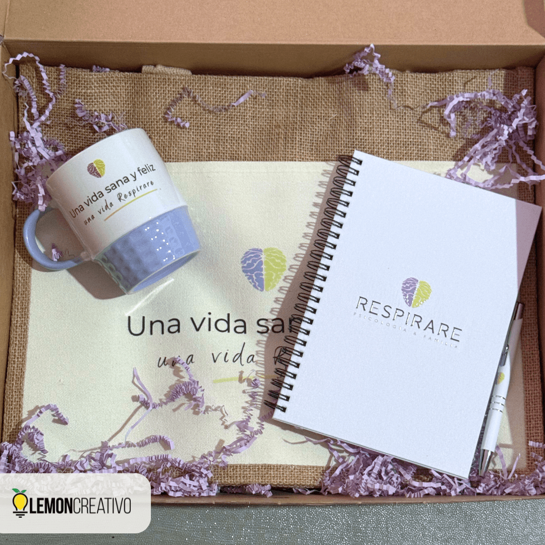 Welcome kit in a kraft box with a mug, tote bag, notebook, and pen branded with a company logo