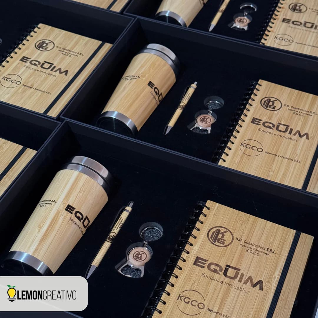Corporate gift boxes with an engraved tumbler, notebook, pen, and keychain, packed and ready for delivery