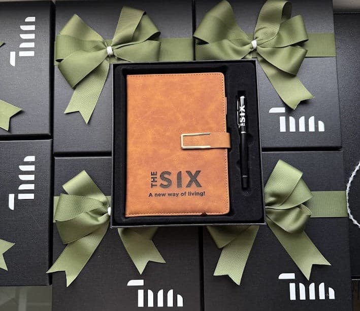 Corporate gift boxes with an engraved notebook and pen, ready for delivery