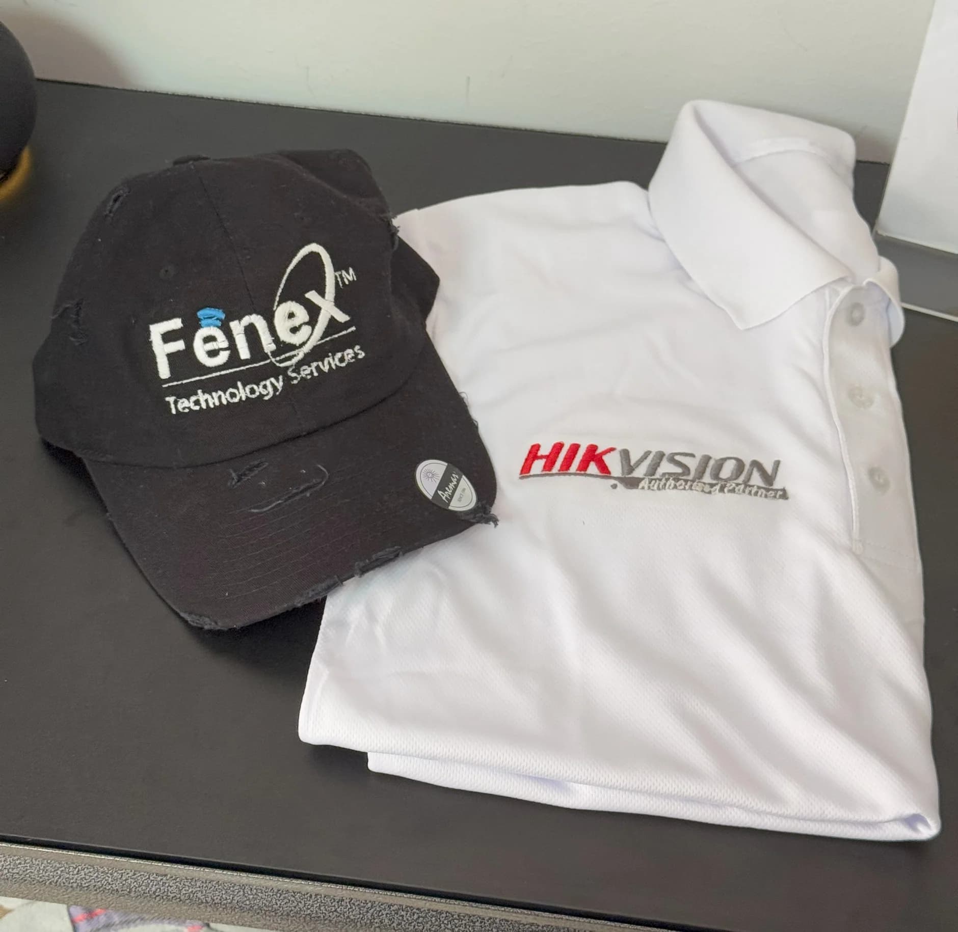 Polo shirts, T-shirts, and caps with an embroidered logo for a company uniform